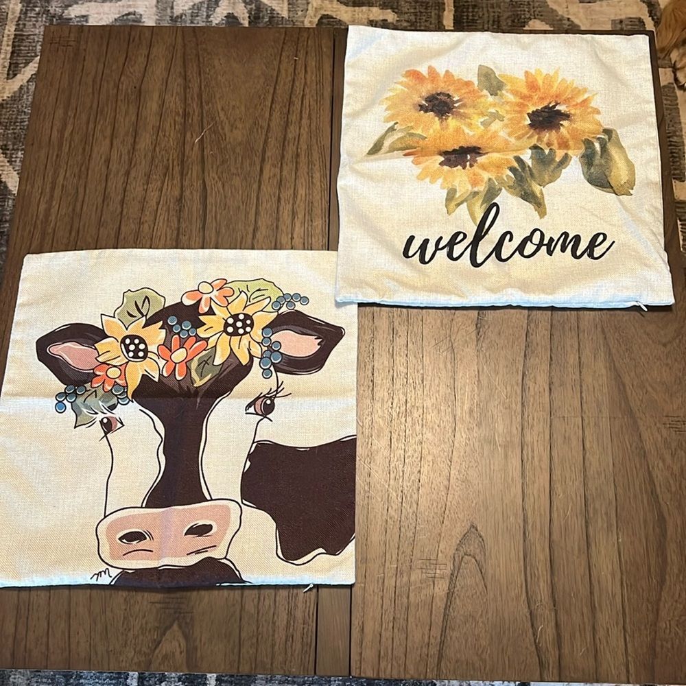 Decorated Pillow covers with cow and flowers.